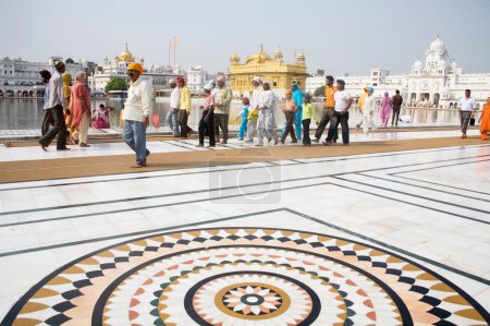 Photo for Marble floral circular pattern, devotees walking around the holy water pool, Swarn Mandir Golden temple, Amritsar, Punjab, India - Royalty Free Image