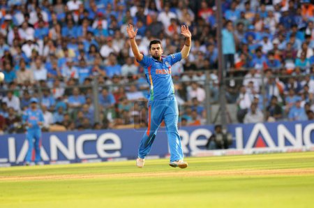 Photo for Indian bowler Virat Kohli reacts in his bowling spell during ICC Cricket World Cup finals against Sri Lanka being played at the Wankhede stadium in Mumbai on April 02 2011 - Royalty Free Image