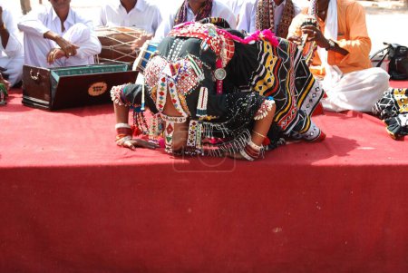 Photo for Folk, Kalbelia dancer picking rings by her eye lid, Jodhpur, Rajasthan, India - Royalty Free Image