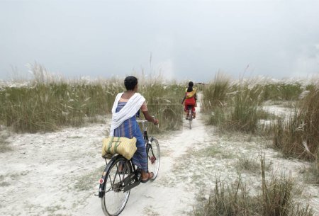 Photo for Women riding cycle, Bongaigaon, Assam, India - Royalty Free Image