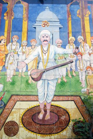 Saint tukaram singing holy song hymn painted on glazed tiles in pasodya vitthal temple , Pune , Maharashtra , India