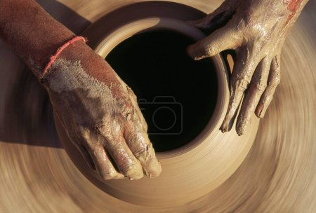 Photo for Pottery , potter giving shape to clay pot on wheel , Bikaner , Rajasthan , India - Royalty Free Image