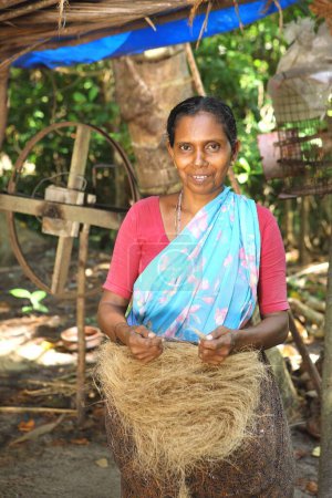 Foto de Keralite mujer haciendo cuerda de coco en casa de campo, método tradicional, Kerala, India - Imagen libre de derechos