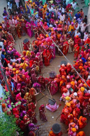 Photo for Women beating men with sticks, Lathmar Holi festival, Mathura, Uttar Pradesh, India, Asia - Royalty Free Image