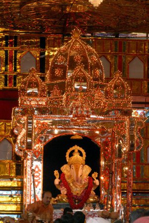 Photo for Idol of Lord Ganesh with magnificent and richly illuminated decoration of Dagdu Seth Halwai Ganapati ; Ganapati festival at Pune ; Maharashtra ; India - Royalty Free Image