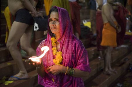 Foto de Mujer sosteniendo diya en mano kshipra river, kumbh mela, madhya pradesh, india, asia - Imagen libre de derechos