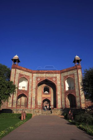 Photo for West gate of Humayun's tomb built in 1570 made from red sandstone and white marble first garden-tomb on Indian subcontinent persian influence in mughal architecture , Delhi, India UNESCO World Heritage Site - Royalty Free Image