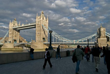 Photo for People walking past at Tower Bridge over Thames river ; London ; U.K. United Kingdom England - Royalty Free Image