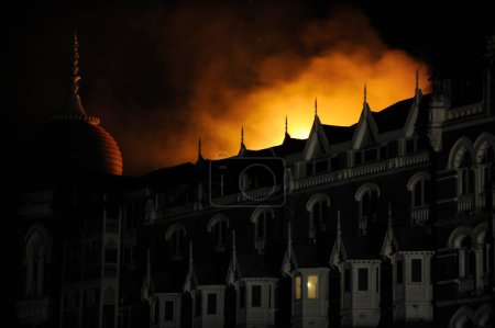 Photo for Fire in old wing of Taj Mahal hotel ; after terrorist attack by Deccan Mujahedeen on 26th November 2008 in Bombay Mumbai ; Maharashtra ; India - Royalty Free Image