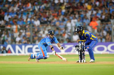 Photo for India batsman Gautam Gambhir L successfully reaches his crease during a run_out attempt by Sri Lankan captain wicketkeeper Sangakkara in the final of ICC Cricket World Cup 2011 match between India and Sri Lanka at The Wankhede Stadium in Mumbai on Ap - Royalty Free Image