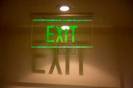Photo for Green color EXIT sign with shadow of the letters ; Palolem beach ; Goa ; India - Royalty Free Image