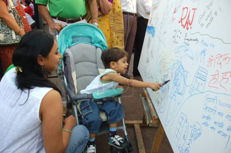 Téléchargez les photos : Enfant sur toile au festival d'art kala ghoda, Bombay Mumbai, Maharashtra, Inde - en image libre de droit
