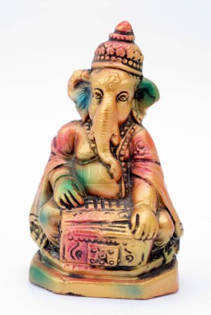 Colourful statue of lord Ganesha elephant headed god playing harmonium , India