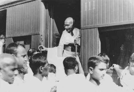 Photo for Mahatma Gandhi alighting from a third class train compartment at Chennai station, Tamil Nadu, India, 1946 - Royalty Free Image
