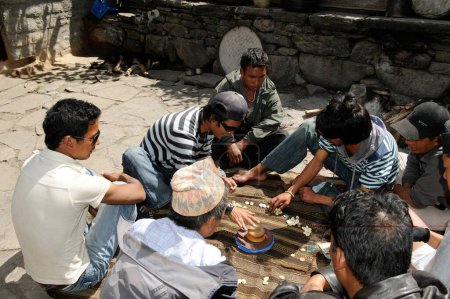 Photo for Men gambling with shells, Koto, Nepal - Royalty Free Image