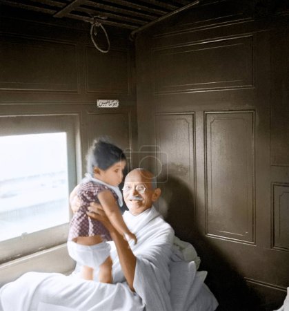 Photo for Mahatma Gandhi playing with child in train compartment, Maharashtra, India, Asia, 1941 - Royalty Free Image