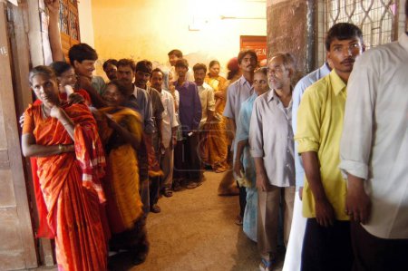 Photo for People standing in a queue to vote during the 2004 Indian Loksabha elections at polling booth at Shivaji Nagar, Govandi, Mumbai Bombay, Maharashtra, India - Royalty Free Image