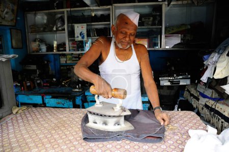Photo for Maharashtrian man ironing, Akluj, Solapur, Maharashtra, India - Royalty Free Image