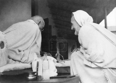 Photo for Mahatma Gandhi and Khan Abdul Gaffar Khan talking about spinning at Khadi Pratishthan ; Sodepur ; 24 Parganas ; Calcutta ; 1946  ; India - Royalty Free Image