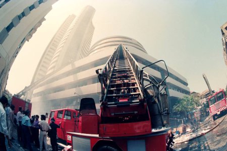 Photo for Fire brigade trying to control the fire occurred in Bombay Stock Exchange after Mumbai bomb blast 93 ; Bombay Mumbai ; Maharashtra ; India - Royalty Free Image