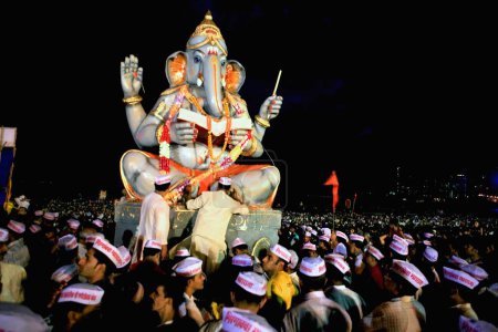 Photo for Idol of lord Ganesha (elephant headed god) ; Visarjan ceremony 2008 ; Girgaum Chowpatty beach ; Bombay Mumbai ; Maharashtra ; India - Royalty Free Image