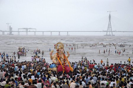 Photo for People taking huge lord ganesha idol for immersion at Chowpaty, Dadar, Bombay Mumbai, Maharashtra, India 2008 - Royalty Free Image
