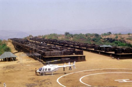 Photo for A Helicopter at the temporary constructed Helipad at the Raigad fort in the Raigad district of Maharashtra ; India - Royalty Free Image