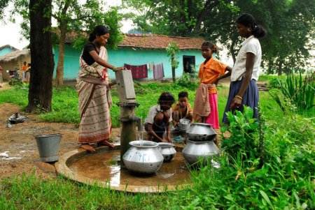 Téléchargez les photos : Ho tribus femmes remplissant des pots avec de l'eau par pompe à main, Chakradharpur, Jharkhand, Inde - en image libre de droit