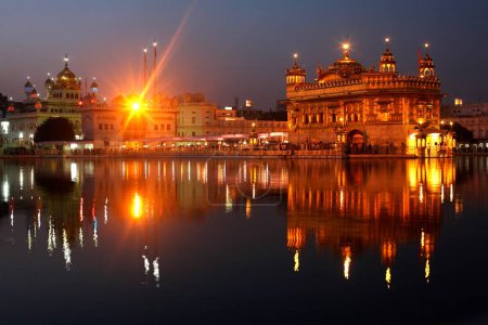 Photo for Glow of Harmandir Sahib or Darbar Sahib or Golden temple reflection in lake in Amritsar ; Punjab ; India - Royalty Free Image