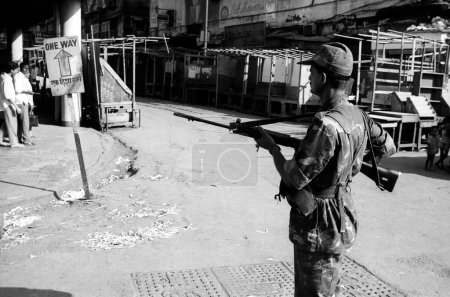 Photo for Army personnel & armed police deployed  to prevent rioting after religious fundamentalists demolished the Babri Masjid in Ayodhya in Uttar Pradesh on 6/12/1992, The rioting continued till January 1993 in Bombay Mumbai, Maharashtra, India - Royalty Free Image