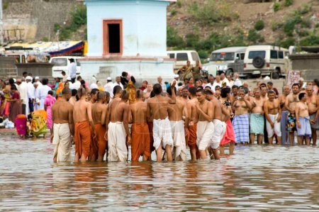 Photo for Sectarian doing religious rites in river chandrabhaga at, Pandharpur district Solapur, Maharashtra, India - Royalty Free Image