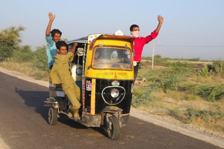 Téléchargez les photos : Personnes prenant des risques à cheval sur autorickshaw, Pushkar, Rajasthan, Inde - en image libre de droit