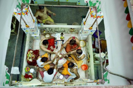 Photo for People performing Rudrabhishek around Shivling Pataleshwar temple Jodhpur Rajasthan India Asia - Royalty Free Image