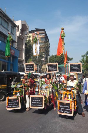 Gudi raised on two wheelers in procession of Gudi padva festival ; Thane ; Maharashtra ; India 2010