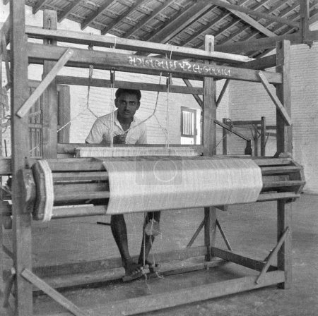 Photo for Old vintage 1900s black and white picture of Indian wooden handloom weaving machine India 1940s - Royalty Free Image