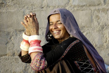 Photo for Rabari tribe smiling young lady wearing bangles in Anjar ; Kutch ; Gujarat ; India - Royalty Free Image