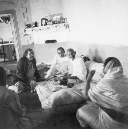 Photo for Pyarelal Nayar, Mahatma Gandhi laughing with Dilip Kumar Roy and his group at Peshawar, October 1938 - Royalty Free Image