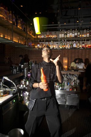 Téléchargez les photos : Barman jonglant avec la bouteille et le verre, Bombay maintenant Mumbai, Maharashtra, Inde - en image libre de droit