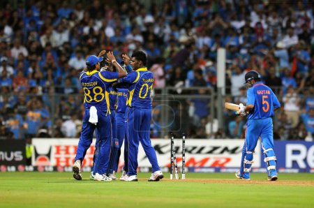 Photo for Sri Lankan team members celebrate wicket of Indian batsman Gautam Gambhir during the 2011 ICC World Cup Final between India and Sri Lanka at Wankhede Stadium on April 2 2011 in Mumbai India - Royalty Free Image