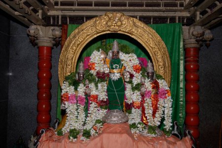 Decorated Urchava deity of lord Subrahmanya with consorts Valli and Deivanai Devasena inside temple; Tirutani ; Tamil Nadu ; India