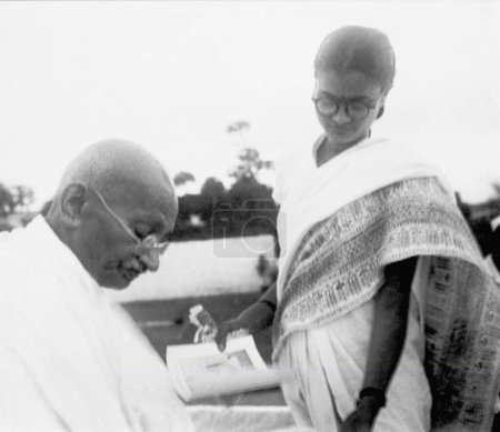 Photo for After prayer Mahatma Gandhi gives an autograph, Pune, 2nd Oct 1944 - Royalty Free Image