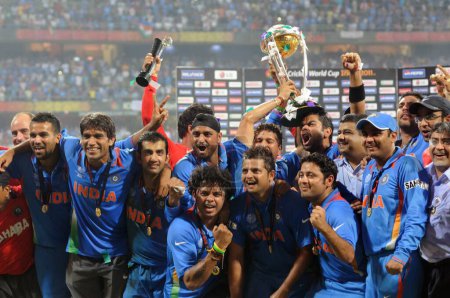 Photo for Indian cricketers celebrate with the ICC World cup trophy after beating Sri Lanka in the ICC Cricket World Cup 2011 final match at The Wankhede Stadium in Mumbai on April 2 2011 India defeated Sri Lanka by six wickets - Royalty Free Image