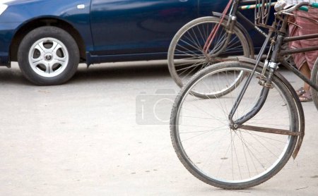 Photo for Street scene, wheels of cycle rickshaw and car on Dhaka, Bangladesh - Royalty Free Image