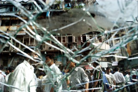 Photo for A view of Zaveri Bazaar from shattered glass panes of damaged cars at the site of bomb blast at busy Kalbadevi area, Bombay Mumbai, Maharashtra, India August 26th 2003 - Royalty Free Image