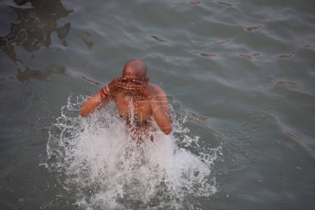 Photo for Devotee taking dip in Ganga river at Haridwar Uttarakhand India Asia - Royalty Free Image