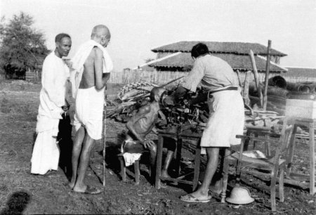 Photo for Mahatma Gandhi observing the examination of Parshure Shastri by Dr. Das at Sevagram Ashram, 1941 - Royalty Free Image