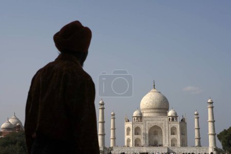 Photo for Sikh man viewing at Taj Mahal Seventh Wonders of World on the south bank of Yamuna river , Agra , Uttar Pradesh , India UNESCO World Heritage Site - Royalty Free Image