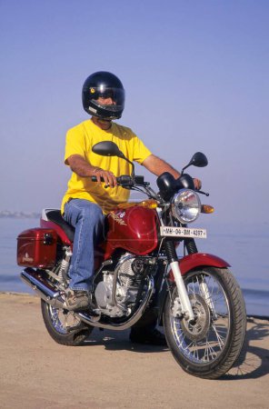 Photo for Man riding motorcycle, india - Royalty Free Image
