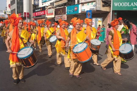 Photo for Women beating drums in procession of gudi padva festival ; Thane ; Maharashtra ; India 2010 - Royalty Free Image