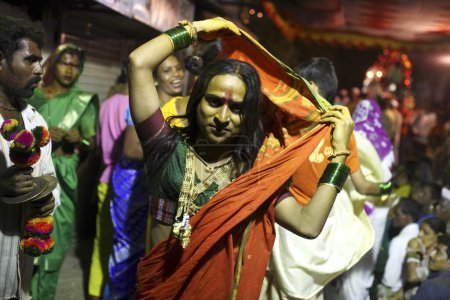Photo for Eunuchs dressed in finery dancing during wedding of eunuchs on occasion of Bewa Purnima at Ghatkopar, Bombay now Mumbai, Maharashtra, India - Royalty Free Image